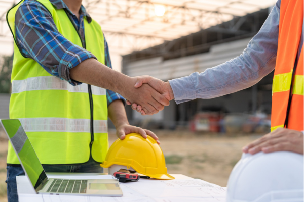 Two installers engaging in a handshake.