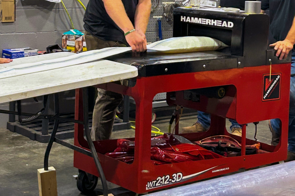 In HammerHead University using the HammerHead Trenchless WT212-3D Wet-out table to wet-out Heliam Scrim liner